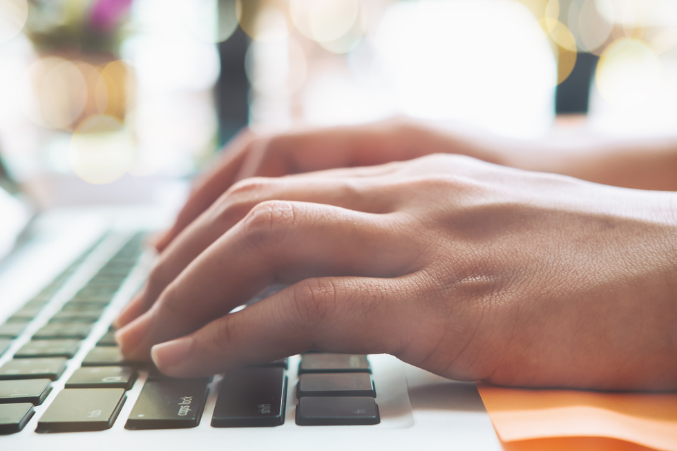 Woman's Hands Typing on a Laptop 